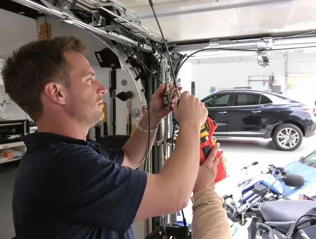 Lawndale Garage Door Repair safety certified technician performing cable replacement in Lawndale